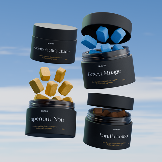 Four perfume containers with scented cubes against a sky background