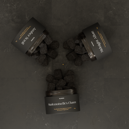 Three containers of black挽回s on a dark background